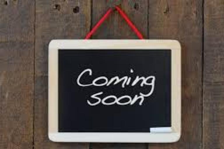 Image of blackboard that says coming soon.