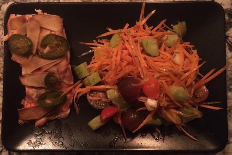 Salmon and carrot salad with tomatoes and cucumber.