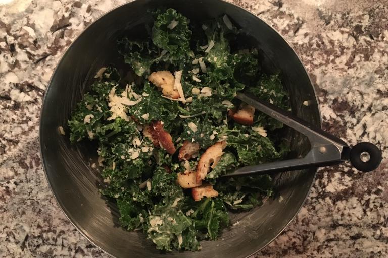 Kale in stainless bowl with croutons